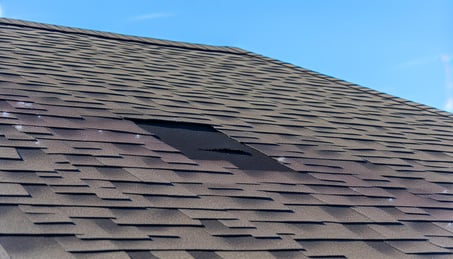 Missing roof shingle after hurricane winds