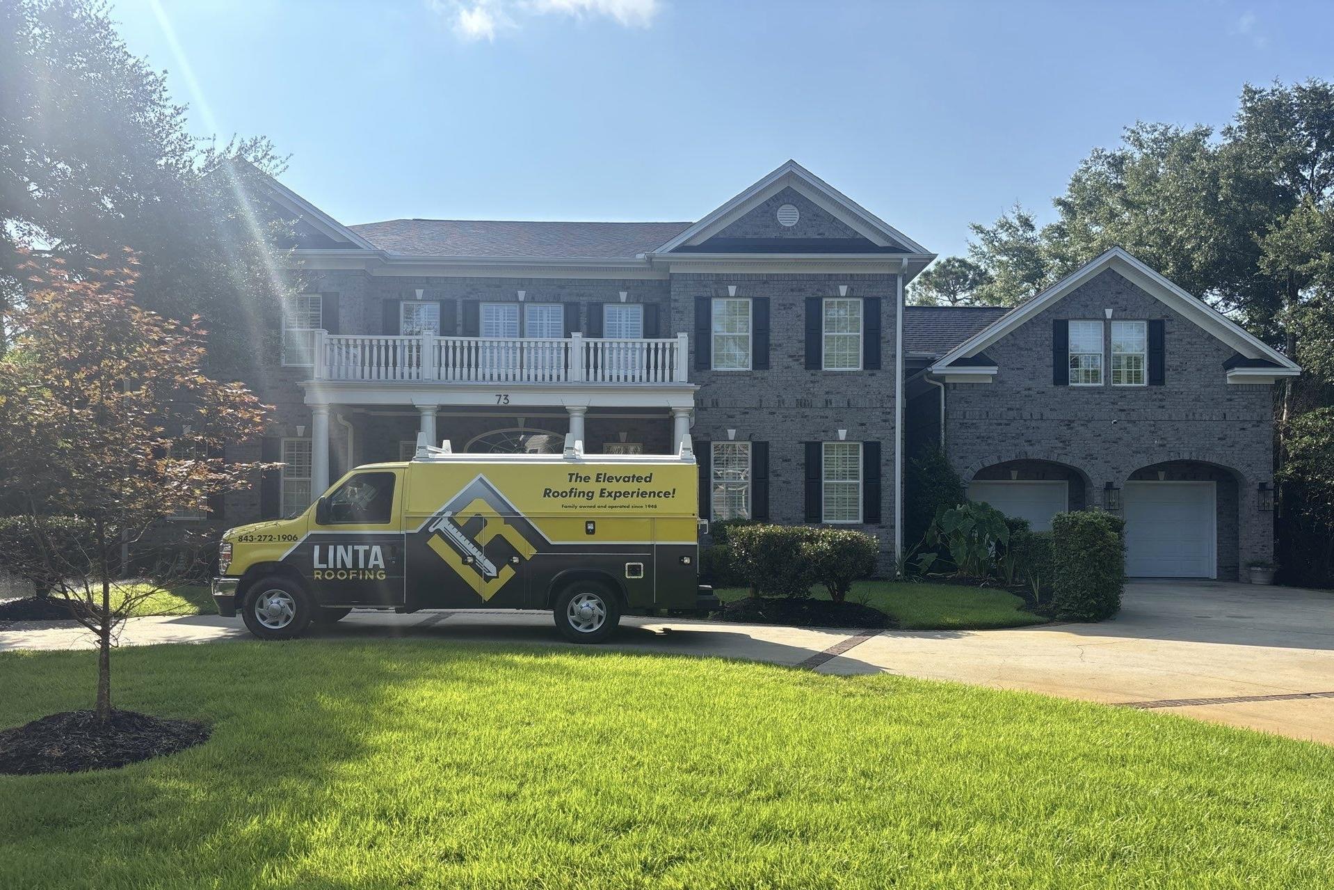 Linta Roofing service van parked in front of a brick home in Myrtle Beach
