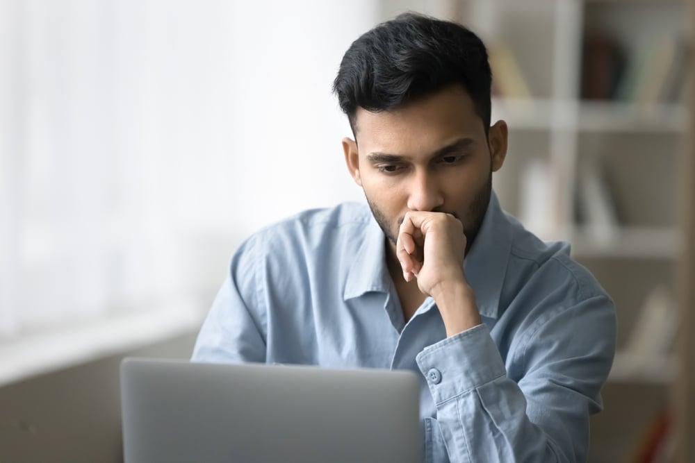 Linta Roofing representative looking at a negative customer review