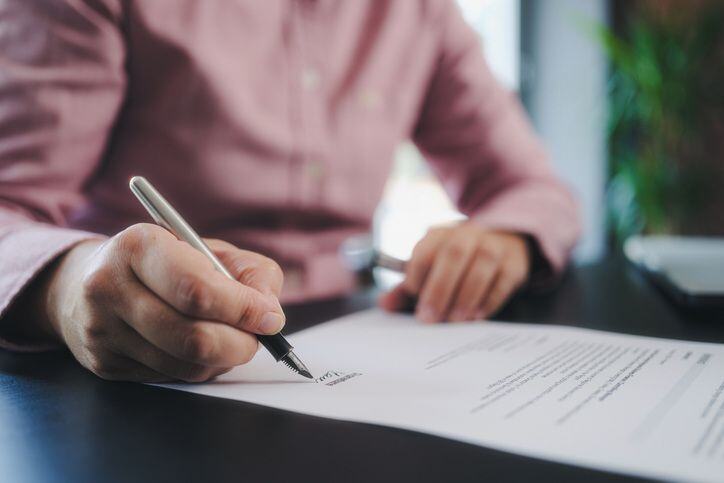 homeowner signing an insurance agreement