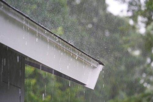 rain falling off of a roof with a drip edge